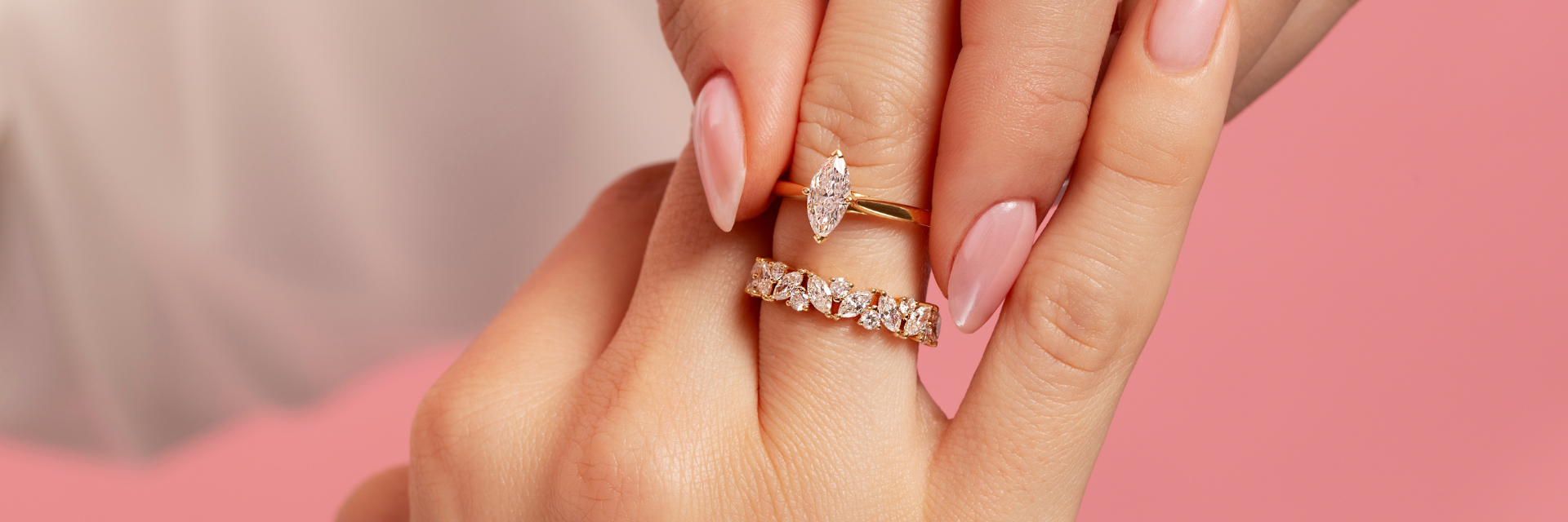 18ct yellow gold marquise cut diamond solitaire engagement ring and diamond eternity ring worn on a model's hand, with alternating marquise and round brilliant cut diamonds in claw settings.
